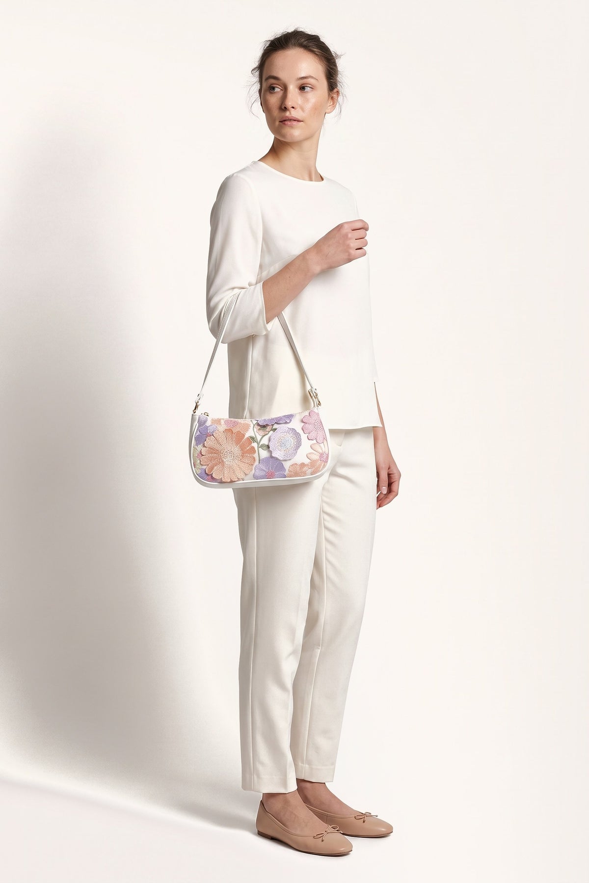 Primrose pastel floral embroidery shoulder bag in white — on model