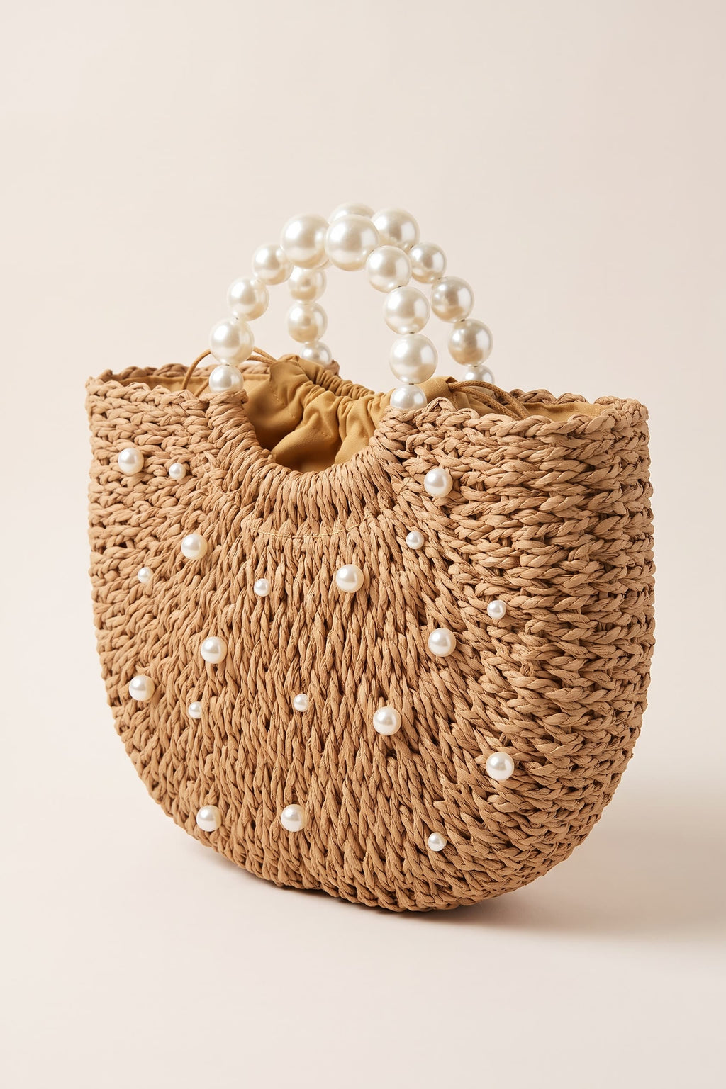 Thea handbag in natural raffia — three-quarter view