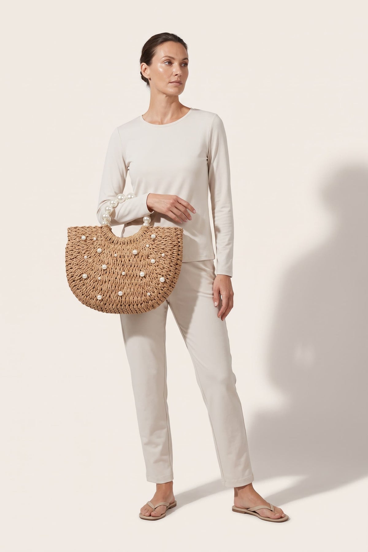 Thea handbag in natural raffia — on model