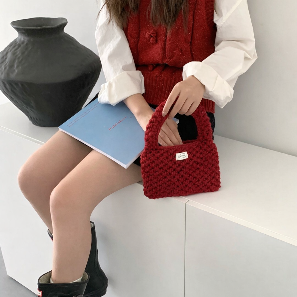 Wren crochet mini tote bag in red — on model