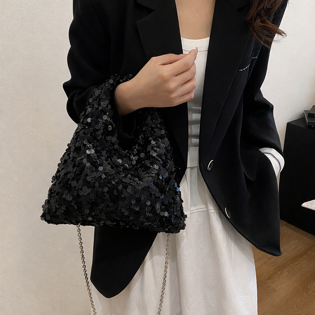 Sylvie sequin hobo bag in black — on model