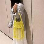 Juniper fringe crochet bag in yellow — on model